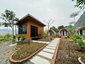 a small house with a pathway in front of it at Bình An Mountain Side Bungalow in Nguyên Ngoại
