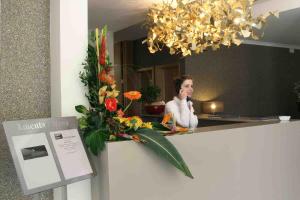 a woman sitting at a counter in front of a mirror at Hotel Douro Inn in Tabuaço