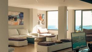 a living room with a couch and a computer in it at Zeus Eleva Miraya in Agios Nikolaos +43 photos