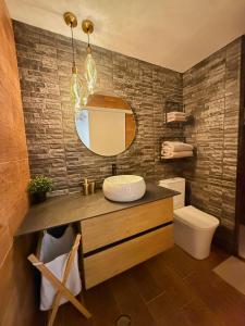 a bathroom with a sink and a mirror and a toilet at Candela 2 en candelaria in Candelaria +11 photos