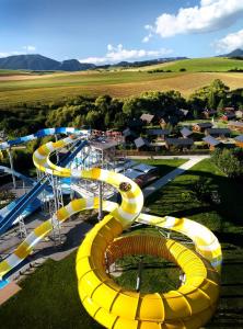 an aerial view of a water slide at a water park at Tatralandia Chatka 112 in Liptovský Mikuláš