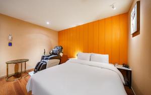 a hotel room with a large bed and a table at 12th Street Stay in Cheongju +56 photos