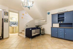 een kamer met een trap met blauwe kasten en een kroonluchter bij Villa Giglio in Torre delle Stelle