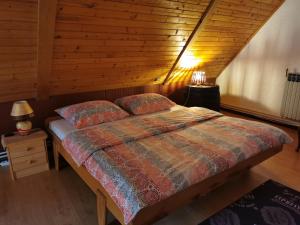 a bedroom with a bed with a wooden ceiling at Holiday House - Hidden in Velebit in Senj