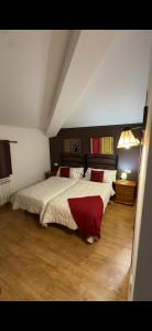 a bedroom with a large bed with red pillows at Casa rural marga in Tardienta