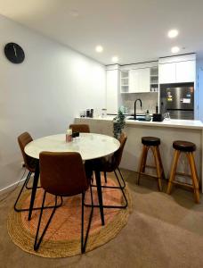 a kitchen with a table and chairs in a room at Bliss in City in Canberra