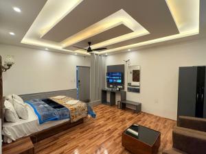 a bedroom with a bed and a tv in a room at Hotel Town Star in Srinagar