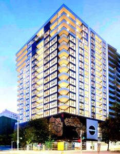 a large tall building with yellow windows at Bliss in City in Canberra