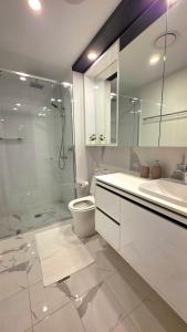 a bathroom with a shower and a toilet and a sink at Bliss in City in Canberra +37 photos