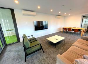a living room with a couch and a table at Bliss in City in Canberra