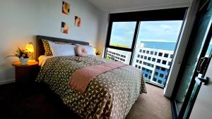 a bedroom with a bed and a large window at Bliss in City in Canberra