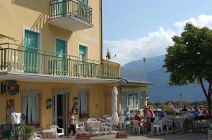 a group of people sitting outside of a building at Hotel Panorama in Riva del Garda