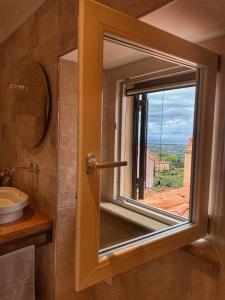 a bathroom with a window with a view at Mia Margot Suite Apartment in Castagneto Carducci +41 photos