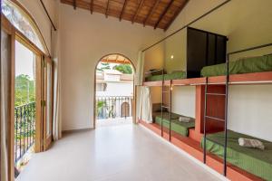 a room with bunk beds and a balcony at Lucky U Hostel in Ahangama +15 photos