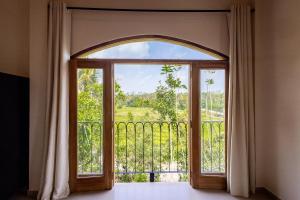 an open door to a balcony with a view at Lucky U Hostel in Ahangama
