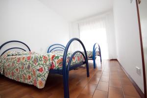 a bedroom with two chairs and a bed and a window at Residence Braida in Caorle +6 photos