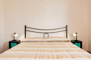 a bedroom with a bed with two night stands at Lily Flat - San Foca in San Foca