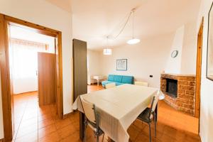 a dining room and living room with a table and chairs at Lily Flat - San Foca in San Foca
