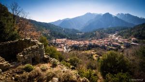 a view of a town in a valley with mountains at E case di u Puntale in Ghisonaccia