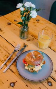 a plate with a sandwich and a bagel on a table at Story Rooms in Olomouc