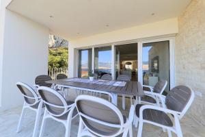 a dining room with a table and chairs at VILLA PAG - SVETA MARIJA in Pag