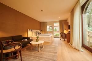 a living room with a couch and a bed at Nordenholzer Hofhotel in Hude +117 photos