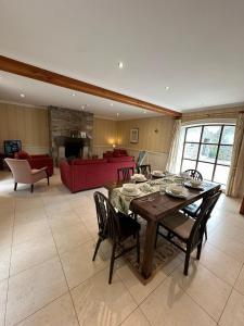 a large living room with a wooden table and chairs at Clós Na Feirme in Galway
