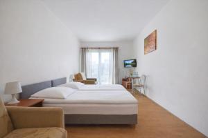 a hotel room with a bed and a chair at Willa Chantal in Jastrzębia Góra +33 photos
