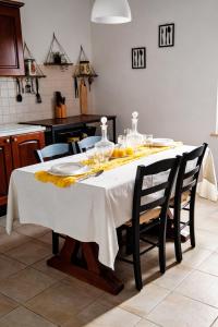 a dining room table with a white table cloth on it at Casa Effe in Cecina