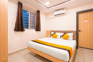 a bedroom with a large bed in a room at Itsy Hotels Saffron Groves in Hyderabad