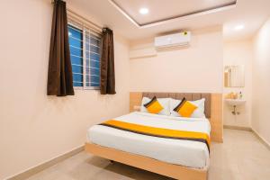 a bedroom with a bed and a window at Itsy Hotels Saffron Groves in Hyderabad +32 photos