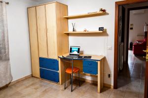 a desk with a laptop computer on top of it at Casa Effe in Cecina