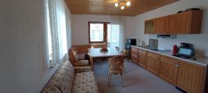 a kitchen with a couch and a table and a counter at Ferienwohnung Liebau in Bayerisch Eisenstein