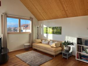 a living room with a couch and a window at Apartment Vinomna in Rankweil