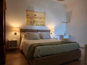 a bedroom with a bed and a painting on the wall at ARISTOCASA in Lecce