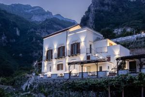 a white building on the side of a mountain at Villa Zagara in Amalfi