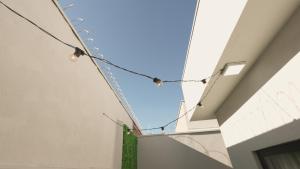 a string of lights hanging from a building at Jahu Center Casas Un 8 in Jaú
