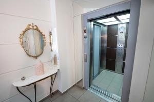 a bathroom with a shower and a sink and a mirror at LUX Hotel 5 mins walk from port of Piraeus and metro station in Piraeus