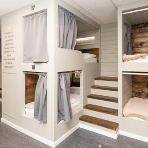 a room with bunk beds and a staircase at Albergue As Pozas Termais in Caldas de Reis