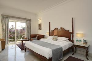 a bedroom with a large bed and a balcony at Fateh Safari Resort by Fateh Collection in Kumbhalgarh +29 photos