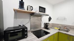 a kitchen with a microwave and a sink at Le Petit Minck in Grand-Fort-Philippe +11 photos