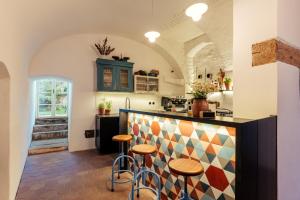 a kitchen with a counter and stools in a room at Am Znaimertor in Retz +16 photos