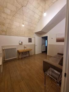 a living room with a couch and a table at B&B Luna Rossa in Altamura