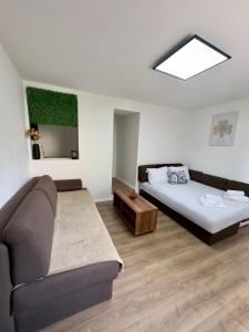 a living room with a bed and a couch at Arija Apartment Sarajevo in Sarajevo