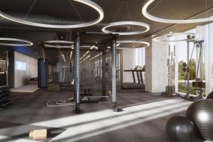 a gym with elliptical equipment in a room at Estrel Tower in Berlin