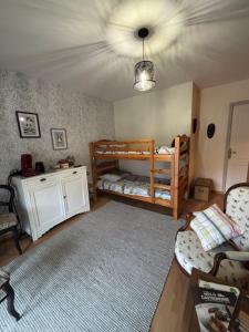 a room with two bunk beds and a ceiling at Maison d’izier in Izier