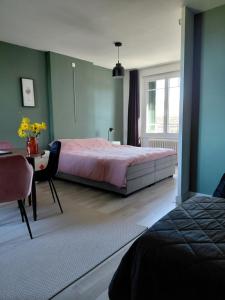 a bedroom with a bed and a desk and a table sidx sidx sidx at B&B Les hirondelles du moulin, Val de Loire in Sassay