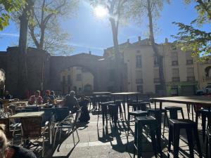 a group of people sitting at tables in a courtyard at The Artist's House in Céret