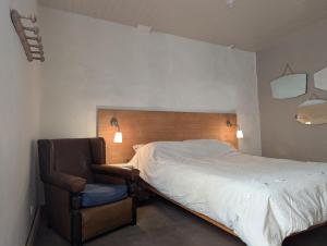 a bedroom with a bed and a chair at The Artist's House in Céret