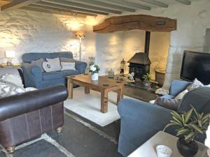 a living room with blue couches and a fireplace at 3 Bed in Blaenau Ffestiniog oc-wah538 in Trawsfynydd